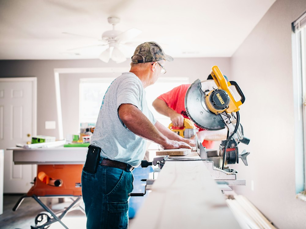 Carpenter standing at a mitre saw