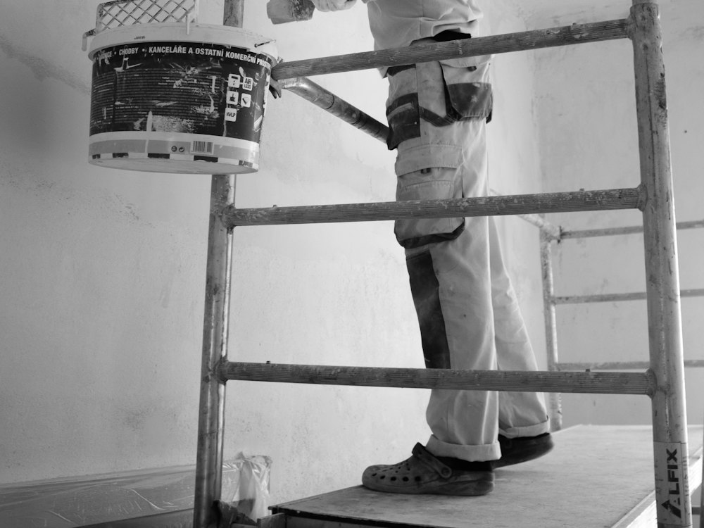 Painter rolling paint onto an interior wall